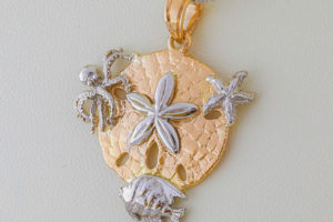 Sand-dollar pendant with an octopus, starfish, and angel fish
