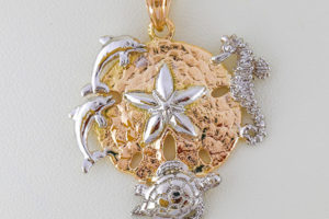 A Sand-dollar Pendant with a Dolphin Couple, Turtle, and Sea Horse