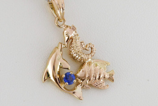 Ocean-Inspired Pendant in Gold with Dolphin, Seahorse, Angelfish & Blue Sapphire