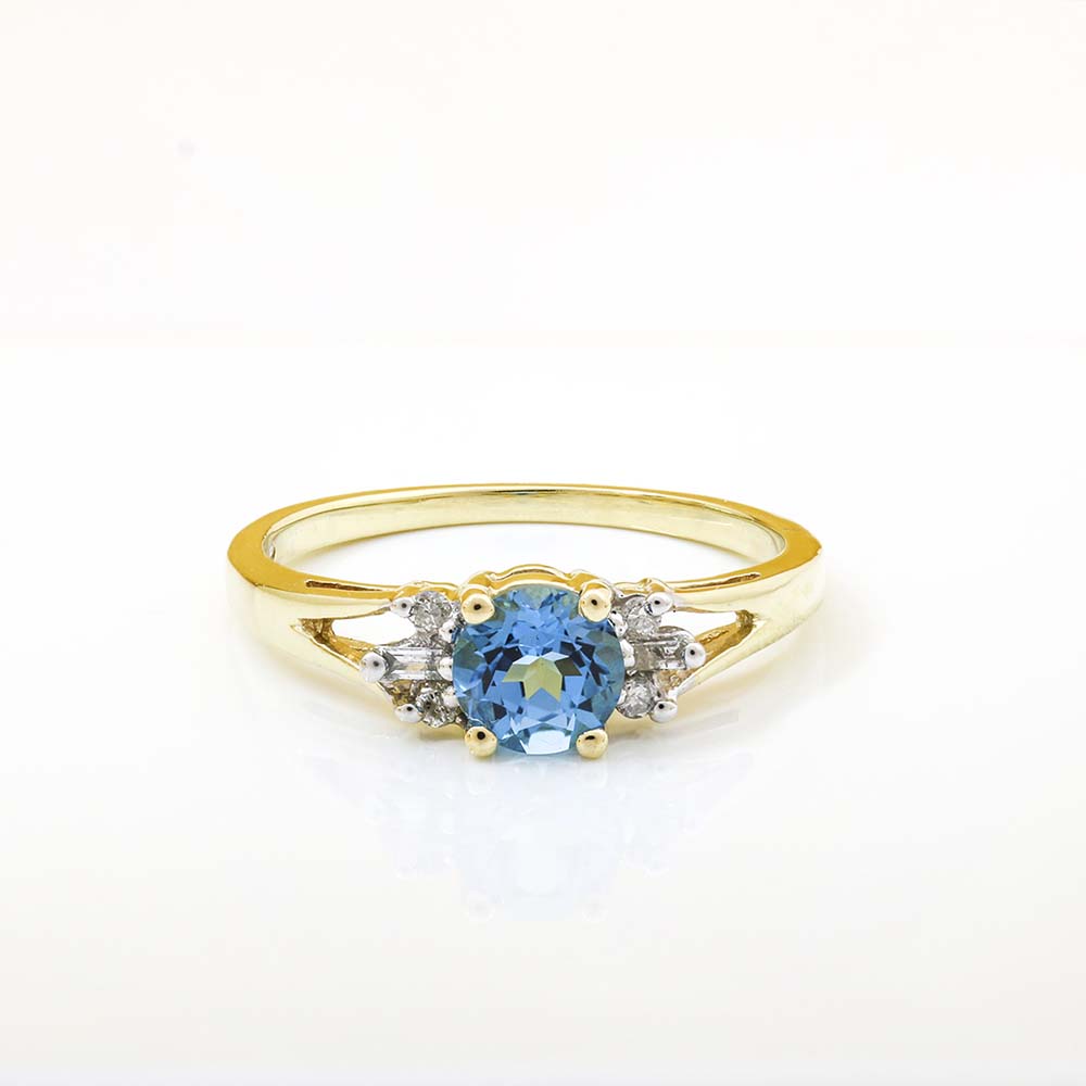 14K gold ring with round-cut blue topaz and white diamond side stones