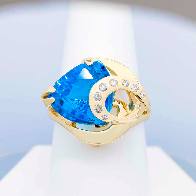 sculptural blue topaz ring, set in yellow gold with sparkling diamond accents
