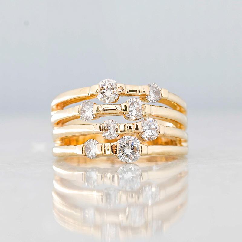 multi-row gold diamond ring features round cut diamonds in a modern, layered design